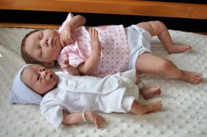 preemie and full term babies lying together