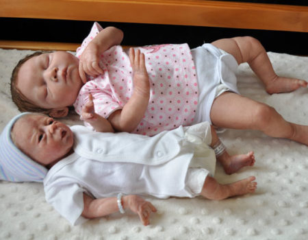 preemie and full term babies lying together
